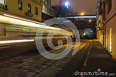 Crowd of people walking along tramway and train railings Stock Photo