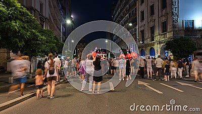 Crowd of people walking on car free pedestrian only street, at night. Bucharest, Romania Editorial Stock Photo