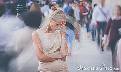 Young woman standing still, feeling down Stock Photo