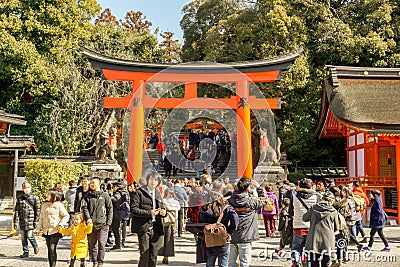 Crowd of peoples and tourists front of a big red Torii gate of Fushimi Inari Shrine. Editorial Stock Photo