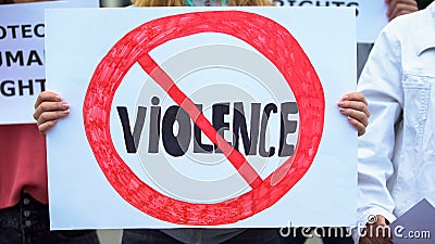 Crowd with posters chanting Stop violence slogans, domestic abuse, human rights Stock Photo