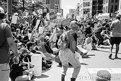 Protestors Holding Up Signs Move to the Street and Begin to Sit Down at Protest of the Killing of George Floyd Editorial Stock Photo