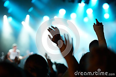 Crowd silhouette, music artist and concert audience listen to song, stage performance or celebrity rock star. Night Stock Photo