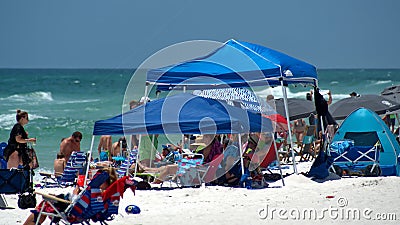 Crowd of tourists with shade umbrellas on the beach Editorial Stock Photo