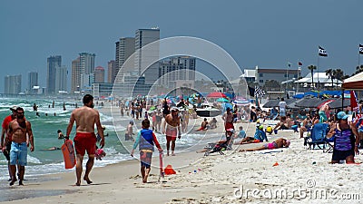 Crowd of tourists under colorful beach umbrellas Editorial Stock Photo