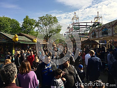 Crowded Fun Fair / Carnival with Roller Coaster in sunny spring weather Kirmes in NeukÃ¶lln / Kreuzberg Editorial Stock Photo