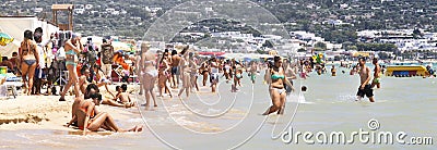 Crowded italian beach summer scene panorama with people. Puglia, Italy Editorial Stock Photo