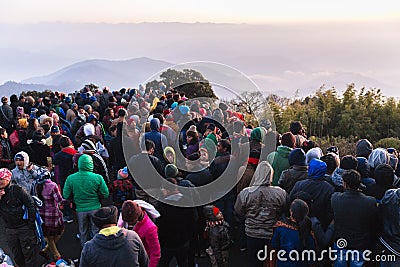 Crowded people are waiting for the first light in the dawn of new year`s day with mountain and fog in background at Tiger Hill. Editorial Stock Photo