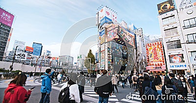 Crowded people walk cross road, car traffic transportation in Shinjuku shopping business district Editorial Stock Photo