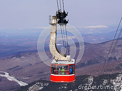 Crowded ski gondola and snow mountains background Stock Photo