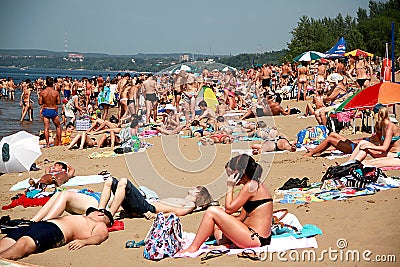 Crowded summer beach, people sunbathe in the sun Editorial Stock Photo