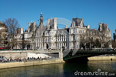 Crowds of people enjoying sunshine in winter on the Seine banks near the Hotel de Ville in Paris France Editorial Stock Photo