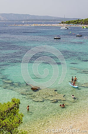 Crowds of people on Golden Cape beach. Golden Cape is the most famous beach in Croatia located on Brac island. Editorial Stock Photo