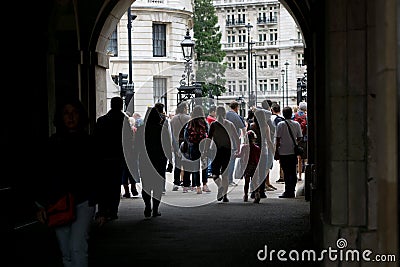 Crowds of tourists pass through archway at Horse Guards Parade in London, England. Editorial Stock Photo