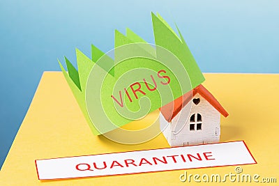 A crown made of paper, a tag with the text and a toy house on a colored background. Concept on the topic of quarantine Stock Photo