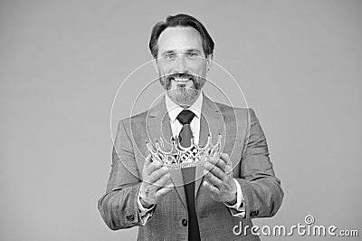 Crown for man who deserves it. Happy businessman hold crown grey background. Kings crown. Royal coronate symbol. Crwn Stock Photo