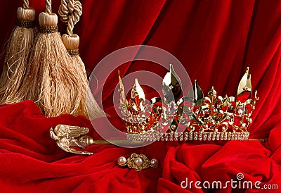 Crown and scepter on red velvet Stock Photo