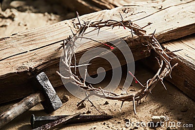 Crown of thorns among cross, hammer with nails Stock Photo