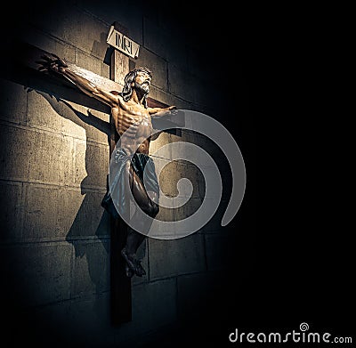 Crucifix in church on the stone wall. Stock Photo