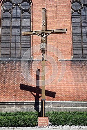 Crucifix near the brick wall Stock Photo