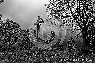 Crucifixion landmark in bleak landscape Good Friday scene, monochrome image Stock Photo