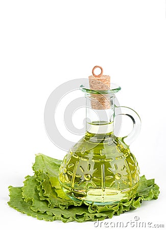 Cruet with oil on lettuce Stock Photo