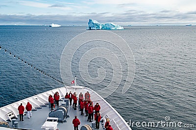 Cruise liner with passengers in front of huge Iceberg, Greenland Editorial Stock Photo