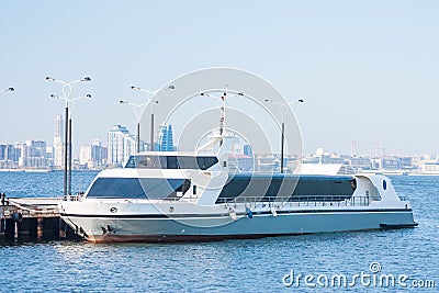 Cruise pleasure boat stands on the pier in the port Bay waiting for passengers. Baku bay. Azerbaijan. Stock Photo