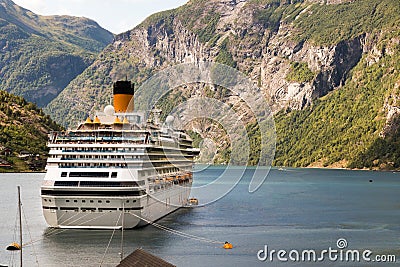 A cruise ship anchored at the Geiranger harbor, Norway Stock Photo