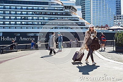 Cruise travel passengers going on board embarking ship with luggage suitcase. Tourist woman with her carry on luggage Editorial Stock Photo