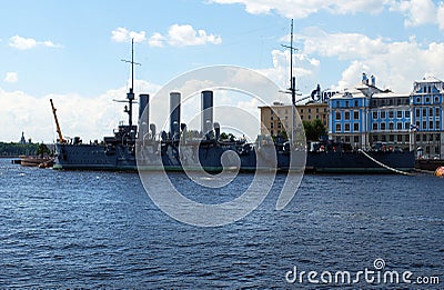 Cruiser `Aurora` on the Petrogradskaya embankment. Summer city landscape. Editorial Stock Photo