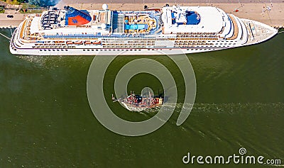 Cruiser ship and small tourist boat in port Gdansk Editorial Stock Photo