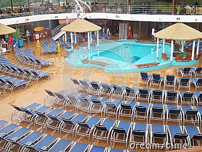 Cruising the Caribbean of the Carnival Magic cruise ship - 11/29/17 - Deck chairs and pool area on the Carnival Magic Editorial Stock Photo