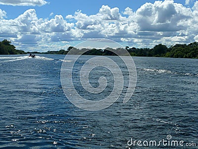 Cruising the endless Zambezi River in Zambia with aluminium motor boats Stock Photo
