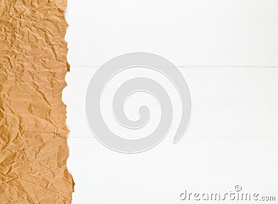 Crumbled brown packing paper on white wooden kitchen table with copyspace Stock Photo