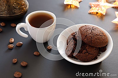 Crumbled chocolate cookies and coffee in small cup on a dark background Stock Photo