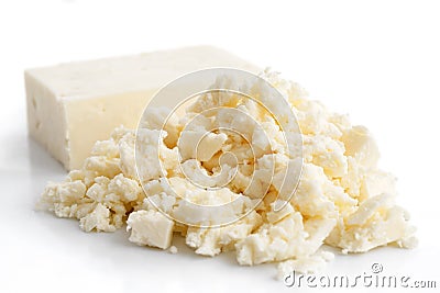 Crumbled white feta cheese isolated on white. Stock Photo