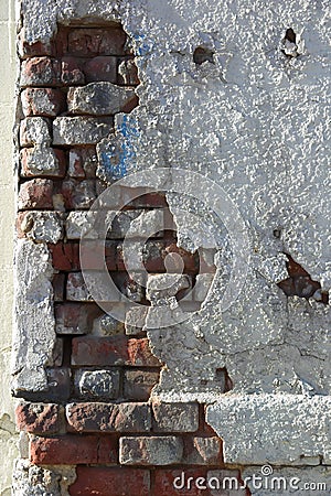 Crumbling wall of brick and plaster Stock Photo