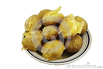 Crumbly jacket potatoes in a plate on a white Stock Photo