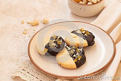 Crumbly vanilla-chocolate homemade cashew cookies and mango marmalade on a light beige background. natural sweets. cozy Stock Photo