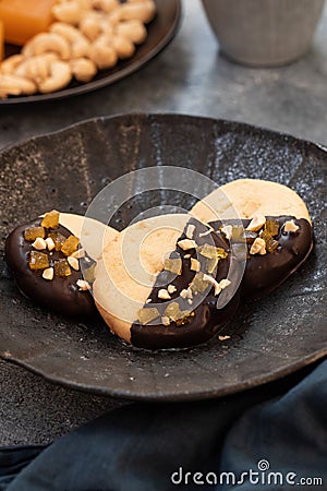 Crumbly vanilla-chocolate homemade cashew cookies and mango marmalade on a light beige background. natural sweets. cozy Stock Photo