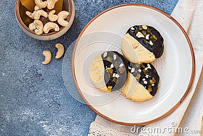 Crumbly vanilla-chocolate homemade cashew cookies and mango marmalade on a light beige background. natural sweets. cozy Stock Photo