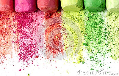 Crumbs and chunks of multicolored chalk, pastels on white paper for watercolor. Yellow, pink, red, green, gray, light green crimso Stock Photo