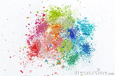 Crumbs of multi-colored chalk on a white background. Joy, Carnival. Panorama. A game for children. Art Stock Photo