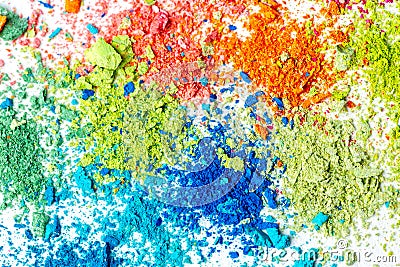 Crumbs of multi-colored chalk on a white background. Joy, Carnival. Panorama. A game for children. Art Stock Photo