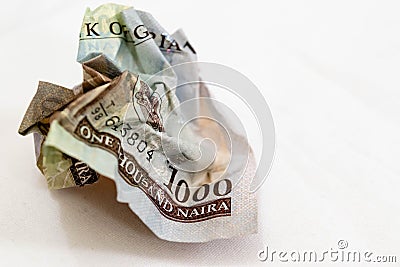 Crumpled banknote in a thousand Nigerian Naira on a White background for value depreciation and loss Stock Photo