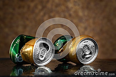 Crumpled beer cans. Two wet empty beer cans with water drops on a brown background, close-up. AMSTEL is a world famous brand from Editorial Stock Photo