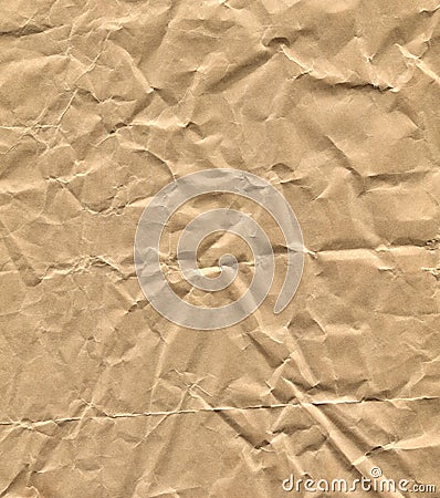 Crumpled brown craft paper background with a textured surface with wrinkles and creases, creating an uneven and rustic appearance. Stock Photo