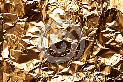 Crumpled gold foil as background Stock Photo