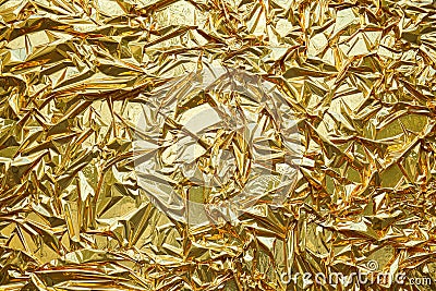 Crumpled, gold metallic foil texture background Stock Photo